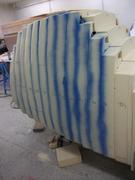 Side view, beginning sanding. Blue paint is here to help to see the part to sand